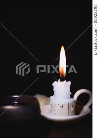 The brightly burning candle on the candlestick, the holy bible, and the words of worship, meditation and prayer of Jesus Christ 89922799