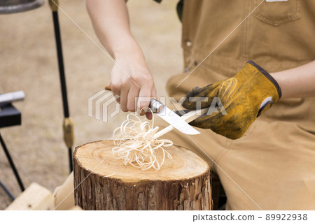 Female hand making feather stick Solo camp image 89922938