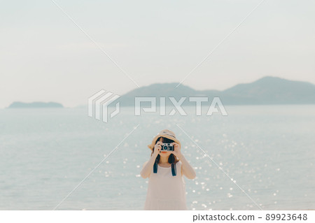 A camera girl in a dress and a beautiful summer sky A camera girl in a dress and a beautiful summer sky 89923648