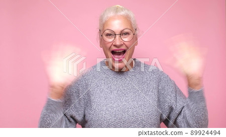 Attractive friendly senior woman smiling happily, saying Hello, Hi or Bye Attractive friendly senior woman smiling happily, saying Hello, Hi or Bye 89924494