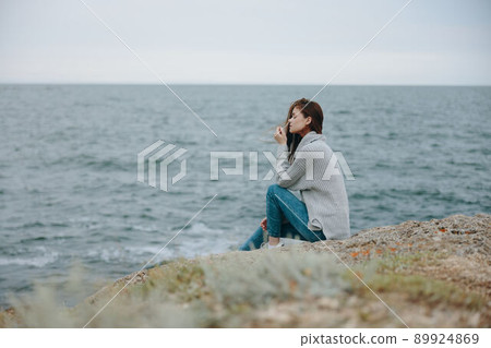 beautiful woman long hair nature rocks coast landscape female relaxing 89924869