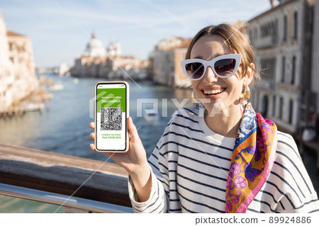 Woman with vaccination certificate while traveling in Italy Woman with vaccination certificate while traveling in Italy 89924886