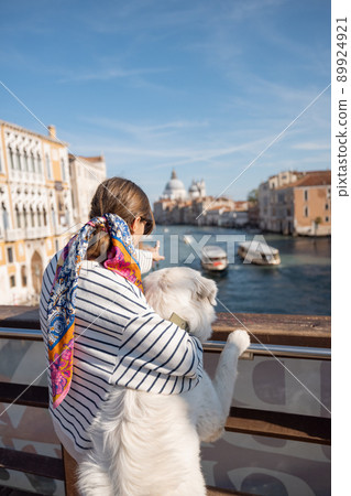 Woman with dog traveling in Venice, Italy 89924921