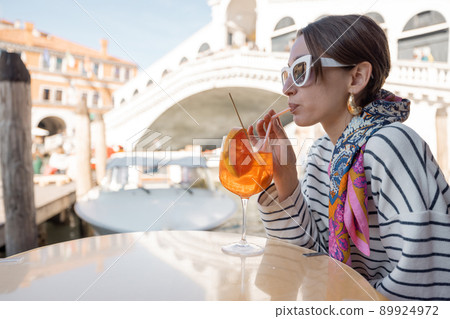 Woman rest at outdoor cafe on Grand Canal, traveling Venice Woman rest at outdoor cafe on Grand Canal, traveling Venice 89924972