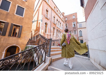 Happy woman traveling in Venice Happy woman traveling in Venice 89925025