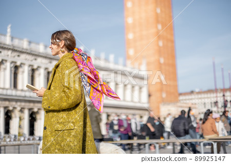Woman walking central square while traveling in Venice Woman walking central square while traveling in Venice 89925147