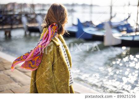 Stylish woman walking in Venice, Italy Stylish woman walking in Venice, Italy 89925156