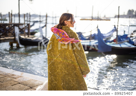 Stylish woman walking in Venice, Italy Stylish woman walking in Venice, Italy 89925407
