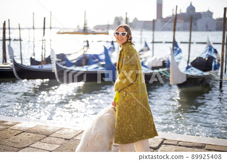 Stylish woman walking in Venice, Italy Stylish woman walking in Venice, Italy 89925408