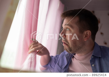 Anxious caucaisian man feel nervous pessimistic look at window wait for someone 89925414