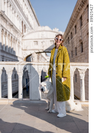 Woman walking central square while traveling in Venice Woman walking central square while traveling in Venice 89925427