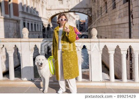 Woman walking central square while traveling in Venice 89925429
