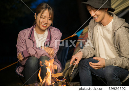 A couple bonfire and chatting on a camp night 89926892