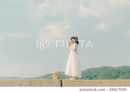 A woman in a dress and a beautiful summer sky A woman in a dress and a beautiful summer sky 89927085