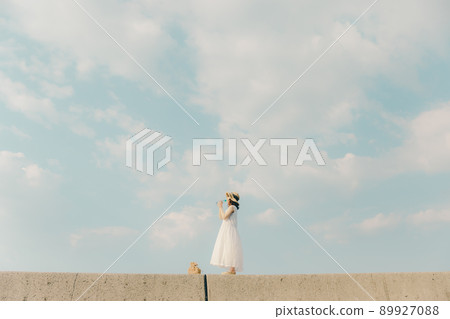 A woman in a dress and a beautiful summer sky A woman in a dress and a beautiful summer sky 89927088