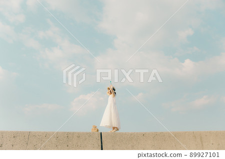 A woman in a dress and a beautiful summer sky A woman in a dress and a beautiful summer sky 89927101