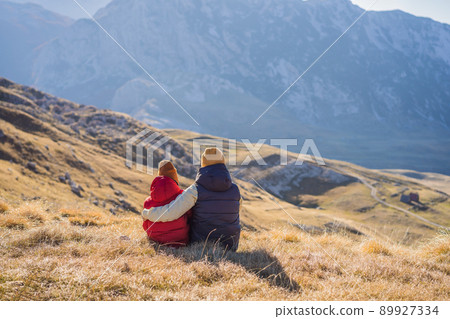 Montenegro. Mom and son tourists in the background of Durmitor National Park. Saddle Pass. Alpine meadows. Mountain landscape. Travel around Montenegro concept 89927334