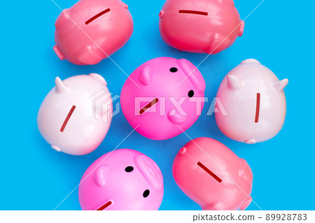 Pink piggy bank on blue background. 89928783