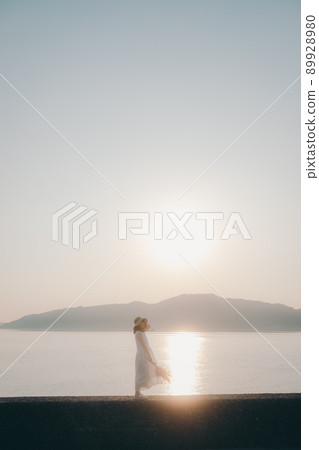 A woman in a dress and a beautiful summer dusk sky A woman in a dress and a beautiful summer dusk sky 89928980