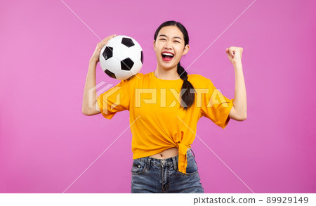 Joyful Asian Young woman over isolated pink background holding a soccer ball, football and people , FIFA World Cup concept Joyful Asian Young woman over isolated pink background holding a soccer ball, football and people , FIFA World Cup concept 89929149