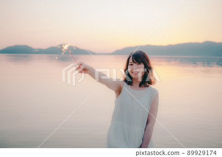 一個美麗的日落，一個穿著裙子的女人和一個美麗的夏天 89929174
