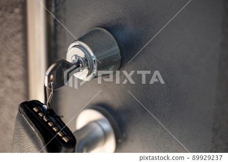 Key with key case inserted in the keyhole Key with key case inserted in the keyhole 89929237