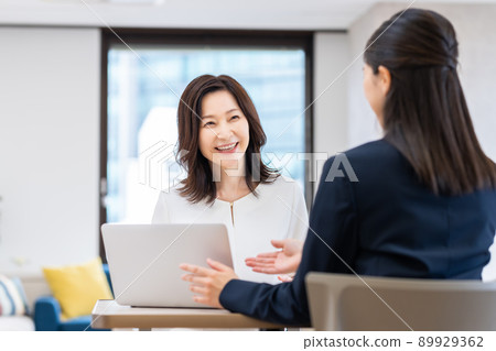 Middle-aged woman consulting a planner Middle-aged woman consulting a planner 89929362
