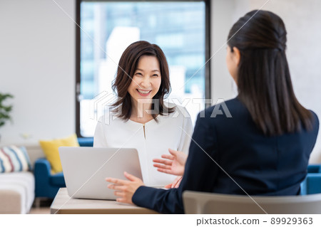 Middle-aged woman consulting a planner Middle-aged woman consulting a planner 89929363