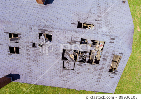 Removing old shingles to prepare a roof for a new installation Removing old shingles to prepare a roof for a new installation 89930105