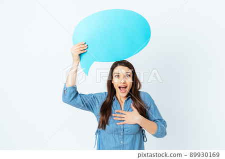 Surprised excited young woman with speech bubble Surprised excited young woman with speech bubble 89930169