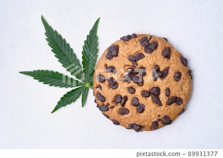Chocolate cookies with cannabis extract close-up. Sweets with CBD oil Chocolate cookies with cannabis extract close-up. Sweets with CBD oil 89931377