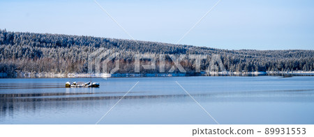 Winter scenery with mountain forests and water reservoir 89931553