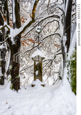 Old Christian memorial in winter forest Old Christian memorial in winter forest 89931571