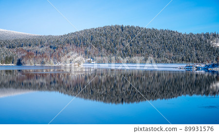 Winter scenery with mountain forests and water reservoir 89931576