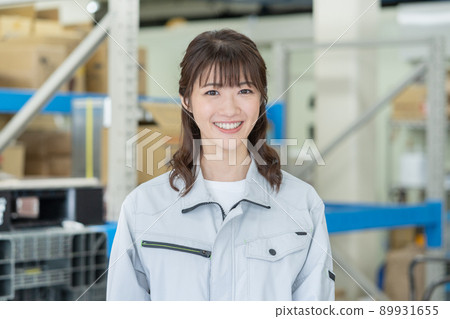 Face up of smiling young woman in distribution center Face up of smiling young woman in distribution center 89931655
