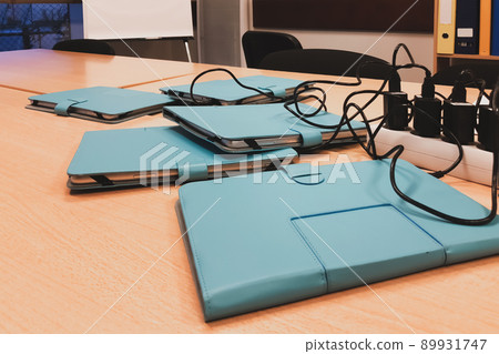 The tablets on the table in the office on recharging 89931747