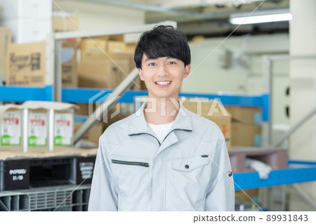 Face up of a young smiling man in a distribution center Face up of a young smiling man in a distribution center 89931843