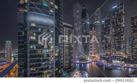Panorama showing Dubai marina tallest skyscrapers and yachts in harbor aerial night timelapse. Panorama showing Dubai marina tallest skyscrapers and yachts in harbor aerial night timelapse. 89932692