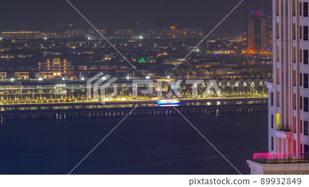 Aerial view of many luxury villas and hotels on the Palm Jumeirah island in Dubai night timelapse. UAE 89932849