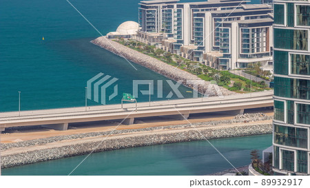 Promenade and Dubai cityscape seen from Dubai marina timelapse. Aerial view to JBR district and Bluewaters Island behind 89932917