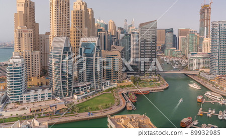 Dubai Marina with several boat and yachts parked in harbor and skyscrapers around canal aerial timelapse. Dubai Marina with several boat and yachts parked in harbor and skyscrapers around canal aerial timelapse. 89932985