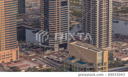 Jumeirah Lakes Towers district with many skyscrapers along Sheikh Zayed Road aerial timelapse. Jumeirah Lakes Towers district with many skyscrapers along Sheikh Zayed Road aerial timelapse. 89933043