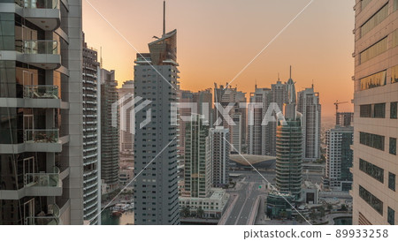 Aerial view on Dubai Marina skyscrapers and the most luxury yacht in harbor morning timelapse, Dubai, United Arab Emirates 89933258