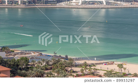 The beach at JBR with golden sand near seaside aerial timelapse The beach at JBR with golden sand near seaside aerial timelapse 89933297