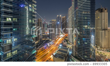 View of the Dubai Marina and JBR area and the famous Ferris Wheel aerial night to day timelapse View of the Dubai Marina and JBR area and the famous Ferris Wheel aerial night to day timelapse 89933305
