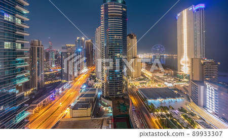 Panoramic view of the Dubai Marina and JBR area and the famous Ferris Wheel aerial night to day timelapse Panoramic view of the Dubai Marina and JBR area and the famous Ferris Wheel aerial night to day timelapse 89933307