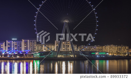 Bluewaters island with modern architecture and ferris wheel aerial night timelapse. Bluewaters island with modern architecture and ferris wheel aerial night timelapse. 89933372