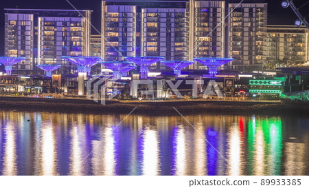Bluewaters island with modern architecture and ferris wheel aerial night timelapse. Bluewaters island with modern architecture and ferris wheel aerial night timelapse. 89933385