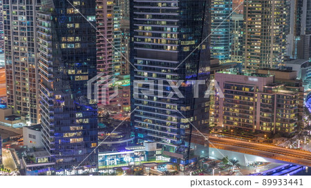 Dubai marina promenade on waterfront along canal aerial night timelapse. Dubai marina promenade on waterfront along canal aerial night timelapse. 89933441