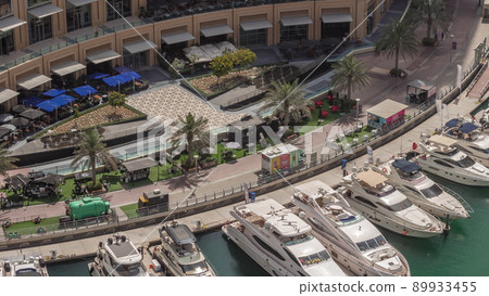 Dubai marina promenade on waterfront along canal aerial timelapse. 89933455